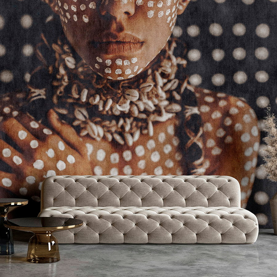 Fotomural Walls by Patel - Photo wallpaper »alani« - African woman with body painting, tapestry structure in the background - Smooth, slightly shiny premium non-woven fabric