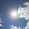 Fotomural Sky blue - photo wallpaper sunshine & blue cloudy sky - AP Digital 1